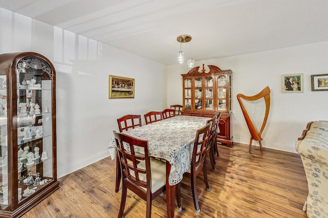 dining space with hardwood / wood-style floors