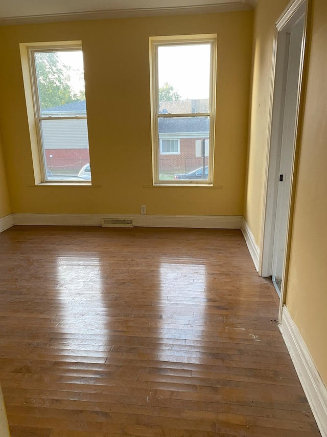 empty room with dark hardwood / wood-style flooring