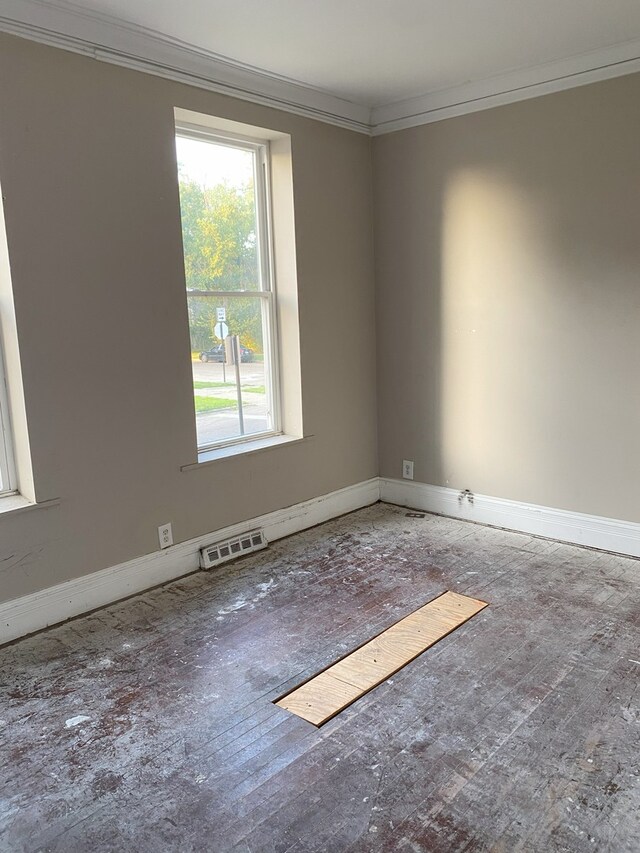 unfurnished room featuring ornamental molding