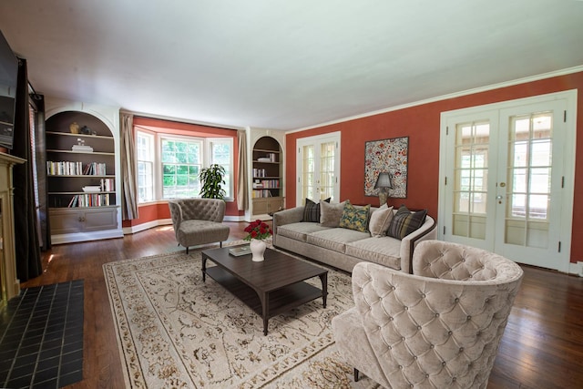 living room featuring built in shelves, dark hardwood / wood-style flooring, french doors, and crown molding