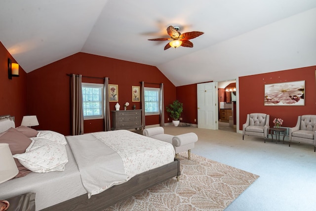 bedroom with connected bathroom, ceiling fan, carpet, and vaulted ceiling