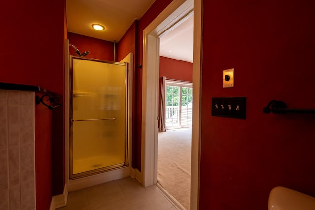 bathroom with tile patterned floors and an enclosed shower