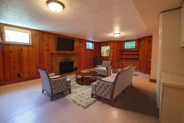 living room featuring wooden walls and a brick fireplace