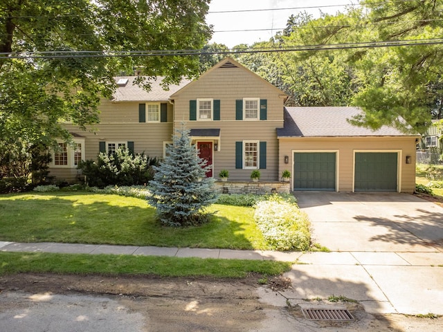 view of front of home with a front lawn and a garage