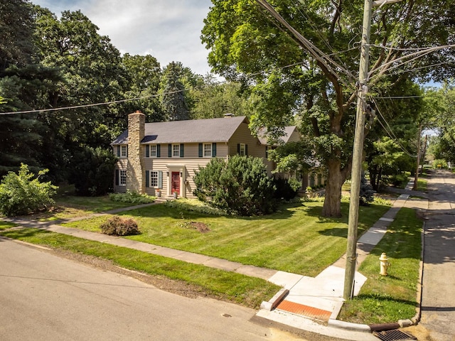 colonial-style house with a front yard