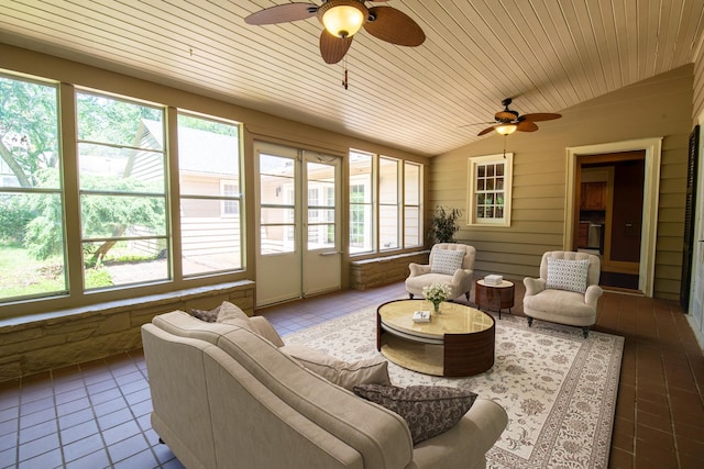 sunroom / solarium featuring a healthy amount of sunlight, ceiling fan, wooden ceiling, and lofted ceiling