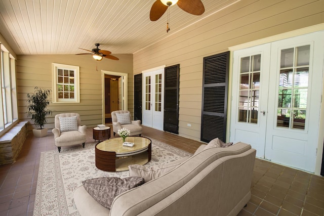 sunroom featuring ceiling fan, wooden ceiling, and lofted ceiling