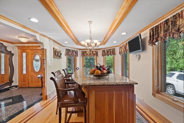 bar featuring a chandelier, recessed lighting, baseboards, ornamental molding, and a tray ceiling