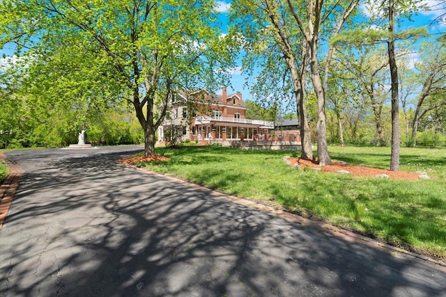 view of front of home with a front yard and a chimney