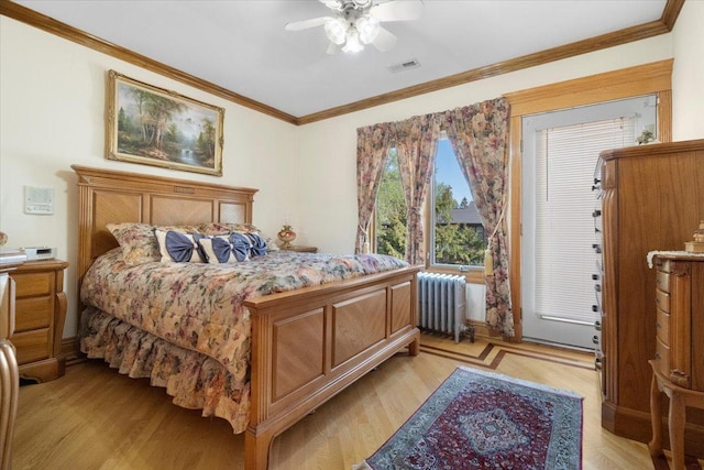 bedroom featuring crown molding, radiator, visible vents, a ceiling fan, and light wood-type flooring