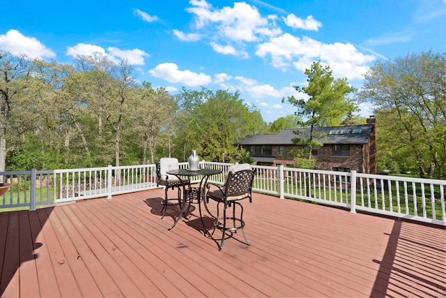 deck with outdoor dining area