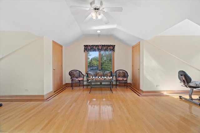 sitting room with light wood-type flooring, ceiling fan, baseboards, and lofted ceiling