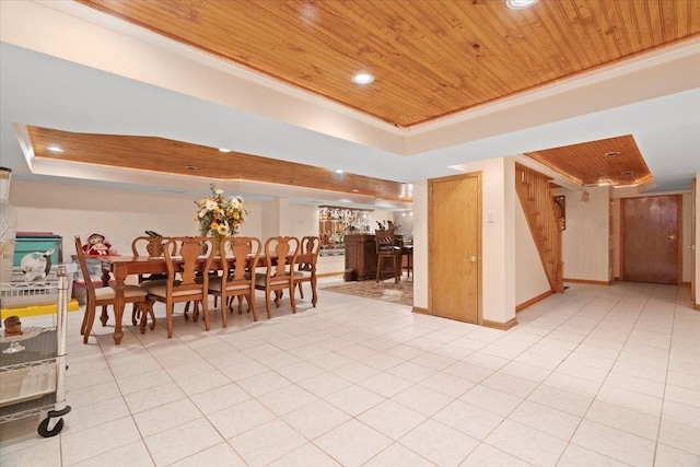 unfurnished dining area with wooden ceiling, a tray ceiling, and ornamental molding