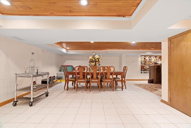 dining space with a tray ceiling, recessed lighting, ornamental molding, wooden ceiling, and baseboards