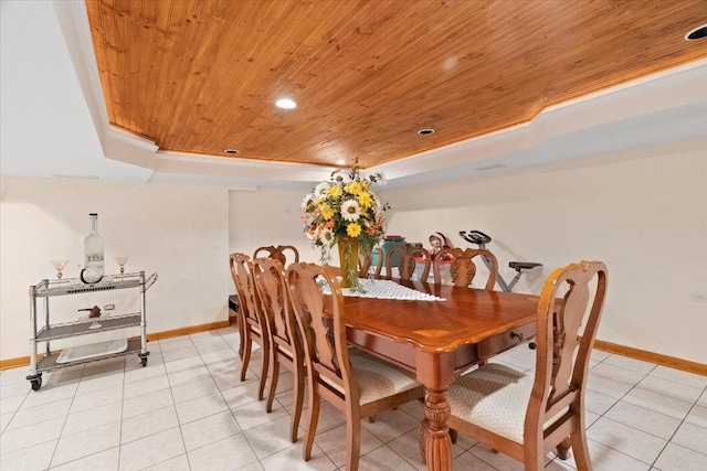 dining space with wood ceiling, baseboards, a raised ceiling, and light tile patterned flooring