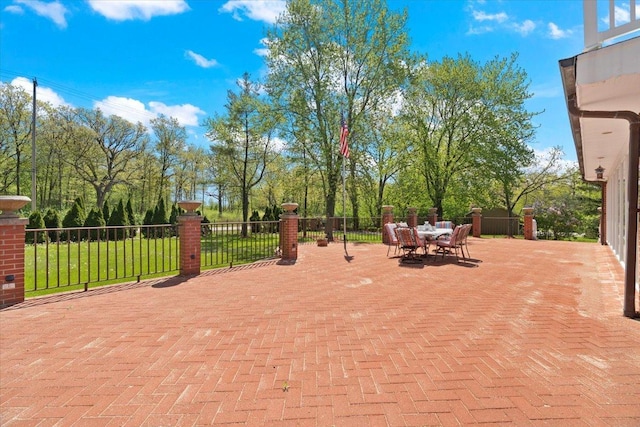 view of patio featuring outdoor dining space and fence