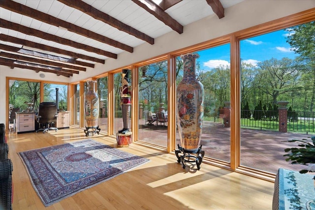 unfurnished sunroom with beamed ceiling