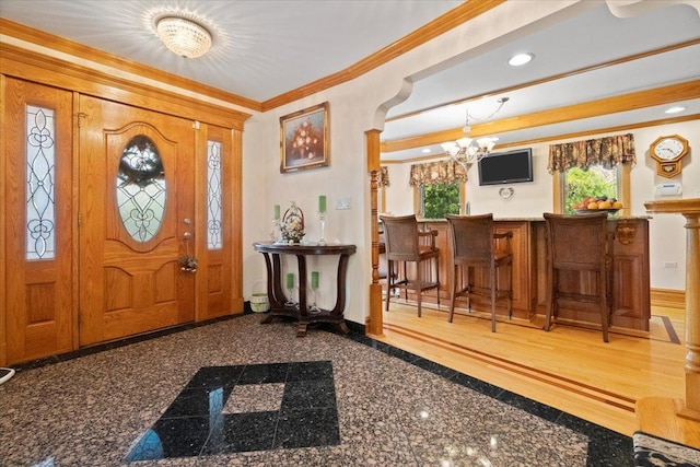 entrance foyer with baseboards, ornamental molding, granite finish floor, a chandelier, and recessed lighting