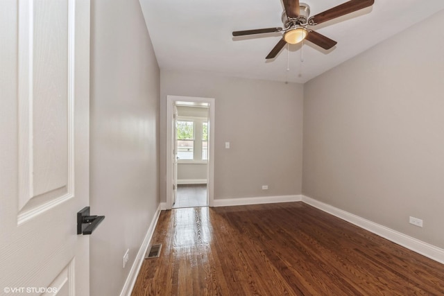 unfurnished room with ceiling fan and dark hardwood / wood-style flooring