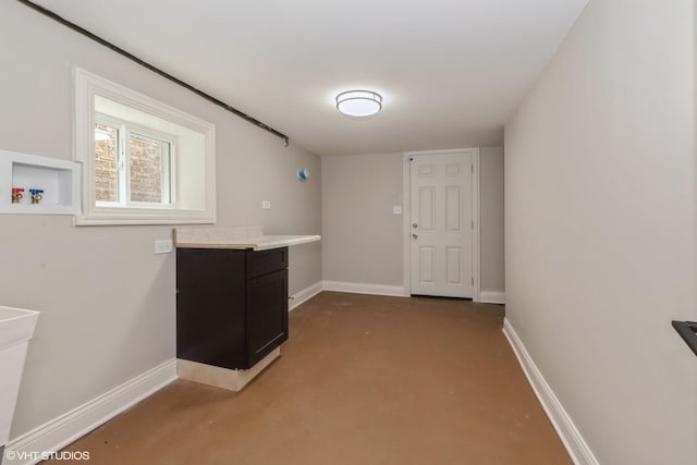 clothes washing area featuring washer hookup and cabinets