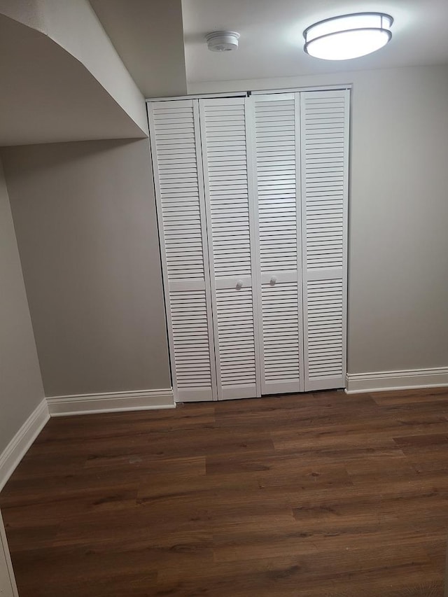 unfurnished bedroom with dark hardwood / wood-style flooring