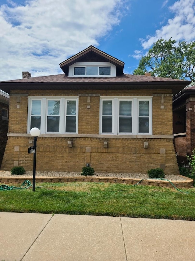 view of home's exterior with a lawn