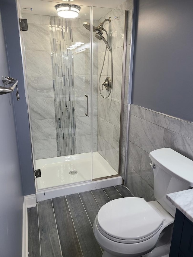 bathroom featuring toilet, tile walls, and walk in shower