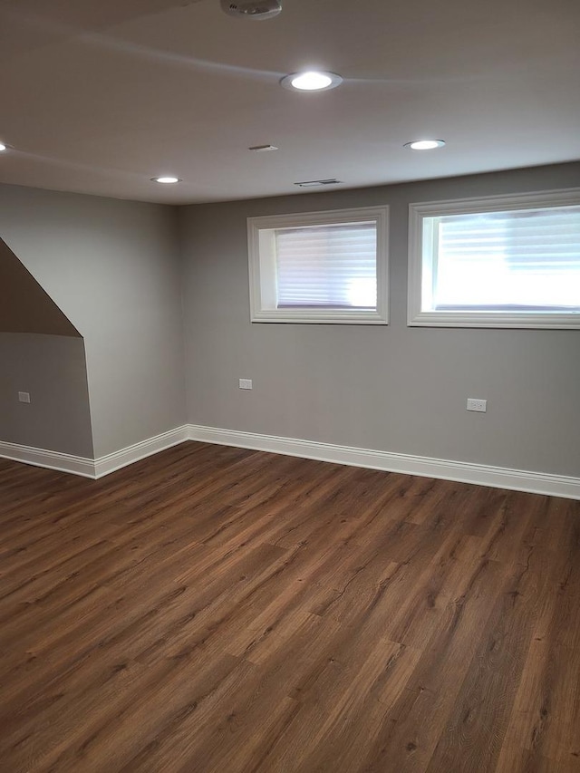 empty room with dark wood-type flooring