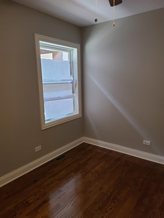 unfurnished room with ceiling fan and dark hardwood / wood-style flooring