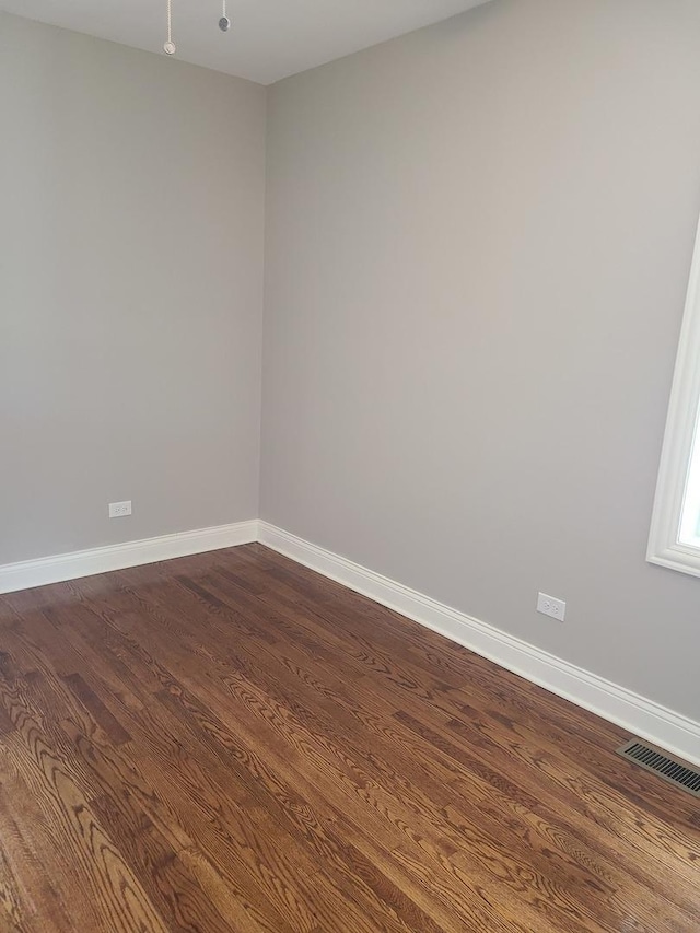 unfurnished room featuring hardwood / wood-style flooring