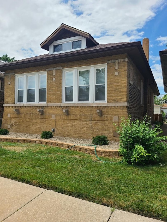 view of home's exterior with a yard