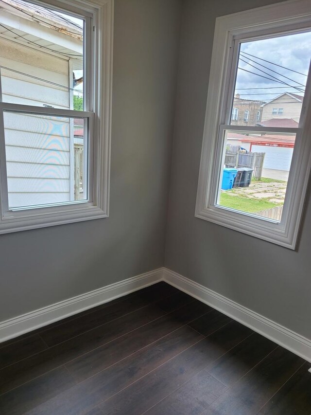 empty room with dark wood-type flooring