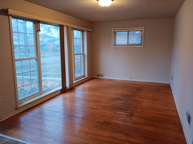 spare room with dark wood-type flooring