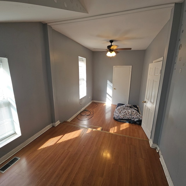 spare room with hardwood / wood-style floors and ceiling fan