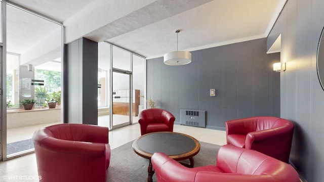 sitting room featuring crown molding and heating unit