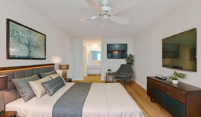 bedroom featuring ceiling fan, light wood-type flooring, ensuite bath, and baseboards