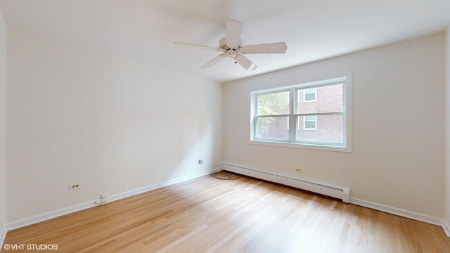 spare room with light wood-type flooring, baseboards, a baseboard heating unit, and ceiling fan