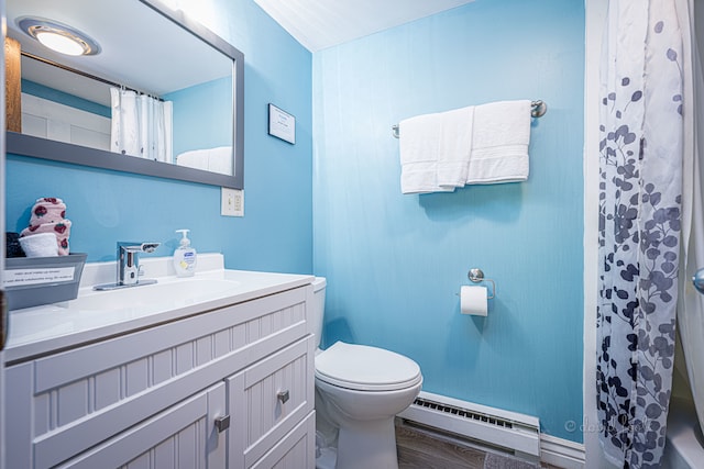 bathroom with hardwood / wood-style flooring, a baseboard heating unit, toilet, and vanity