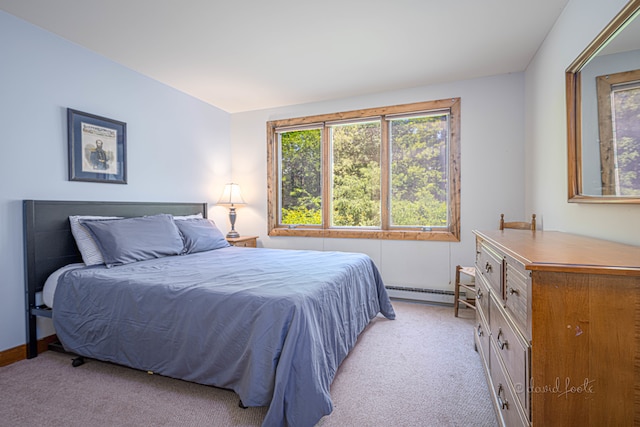 bedroom featuring a baseboard radiator and light colored carpet