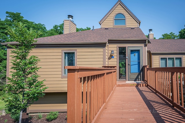 back of house with a deck