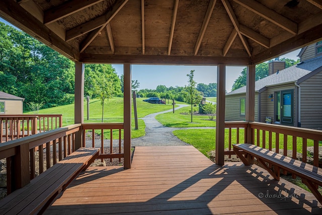 wooden terrace with a gazebo and a lawn