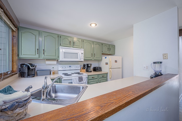 kitchen featuring green cabinets, wood counters, white appliances, and sink