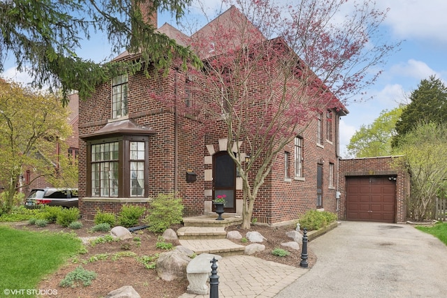 tudor house featuring a garage