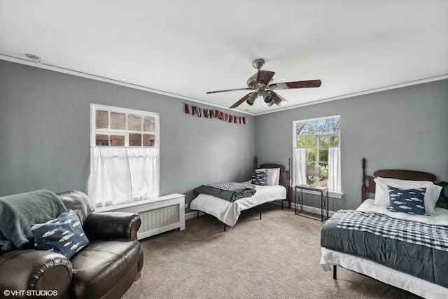 carpeted bedroom featuring ceiling fan and ornamental molding