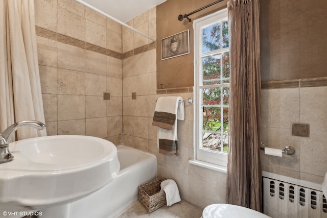 bathroom featuring shower / tub combo, tile walls, radiator, and toilet