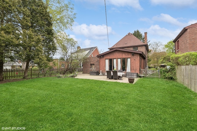 rear view of house featuring a patio and a lawn