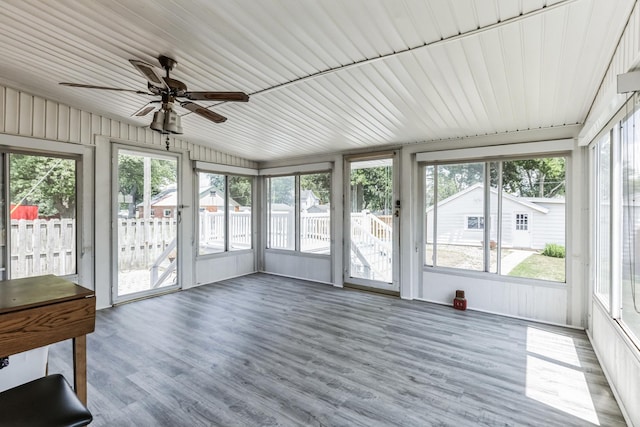 unfurnished sunroom with vaulted ceiling and ceiling fan