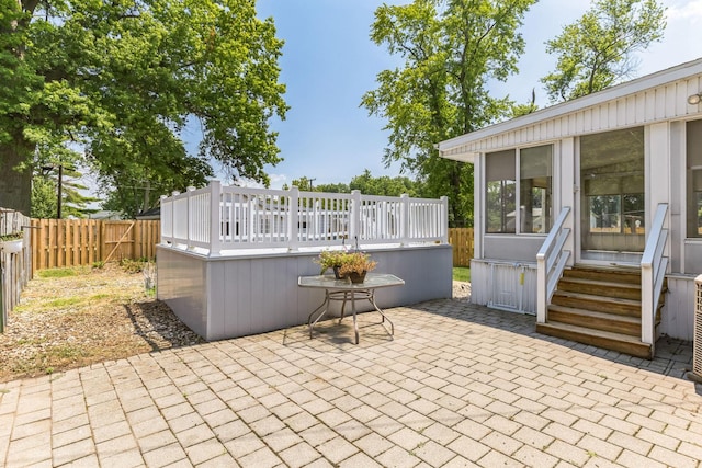 view of patio / terrace featuring a sunroom and a deck