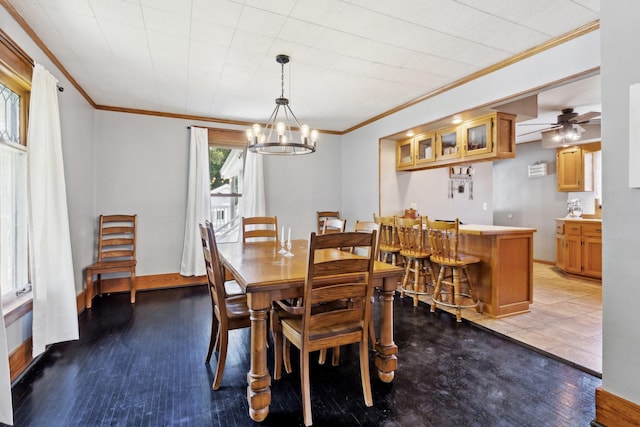 dining room featuring ornamental molding, hardwood / wood-style floors, and a notable chandelier