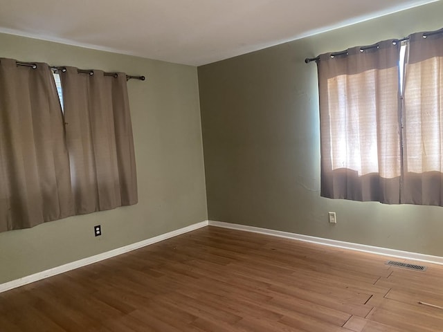 spare room with hardwood / wood-style floors